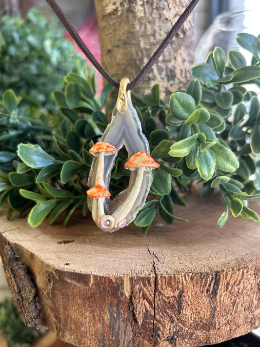 Hand sculpted mushroom/ natural geode slice pendant with crystal accents on brown cording